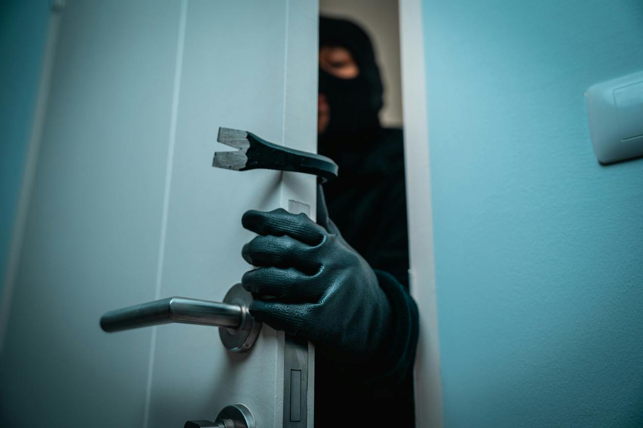 man braking into a house