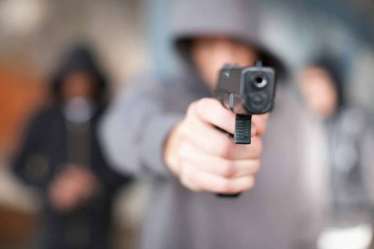 man holding up a gun