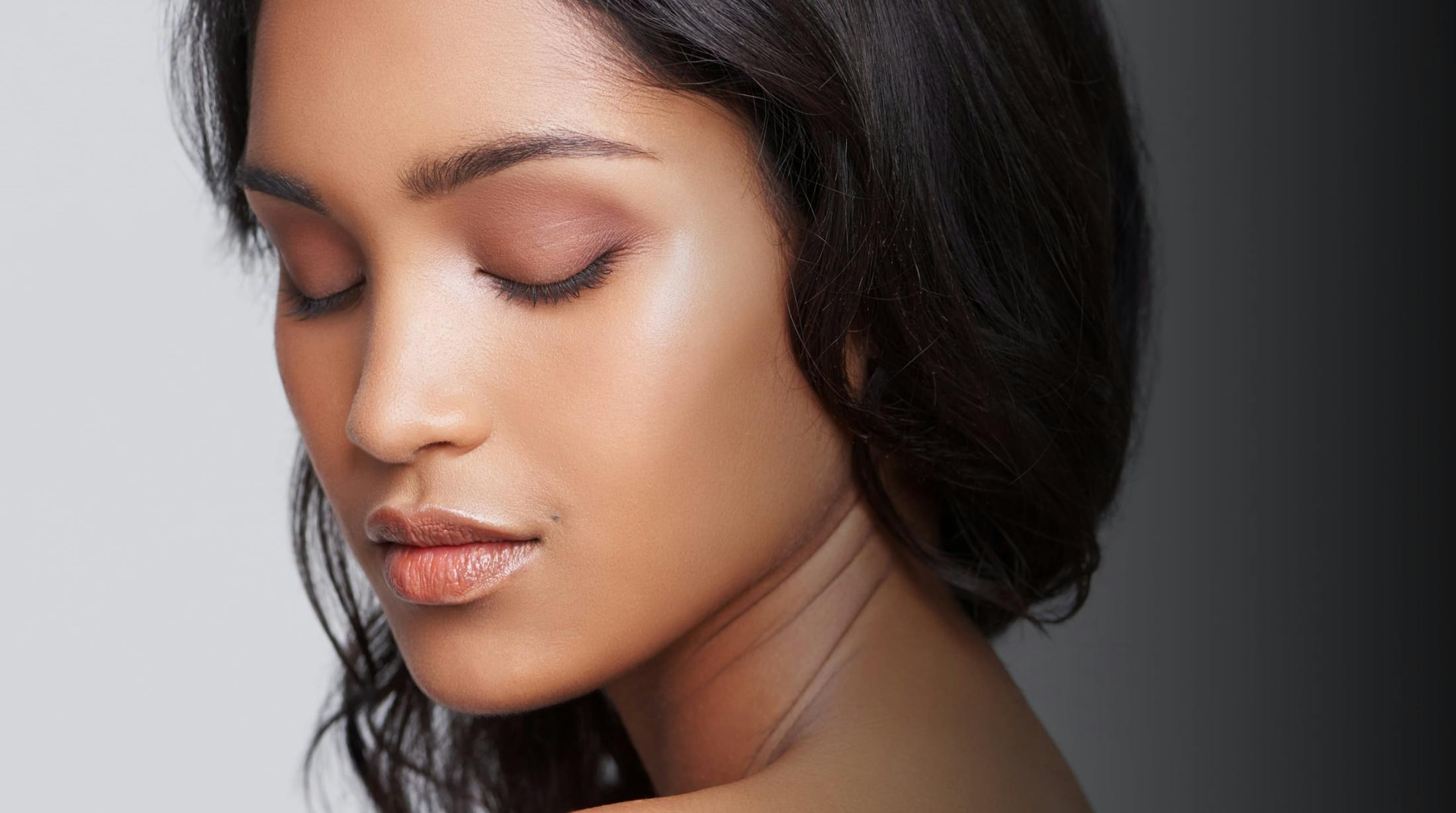 Woman with clear skin closing her eyes
