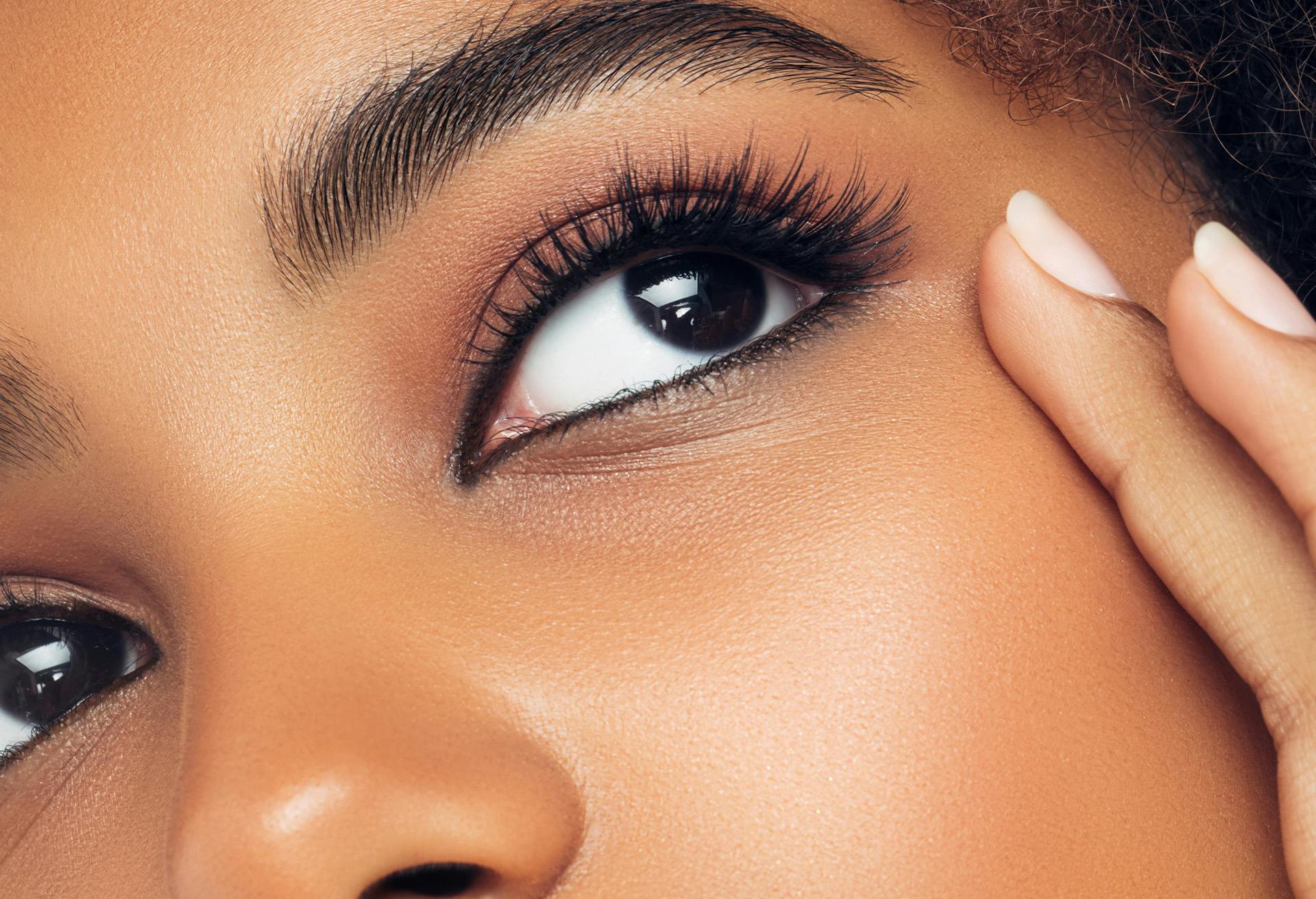 Woman's eye with long eyelashes wearing eyeliner