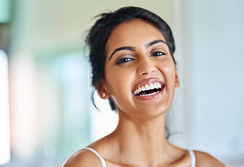 Woman with dark hair laughing