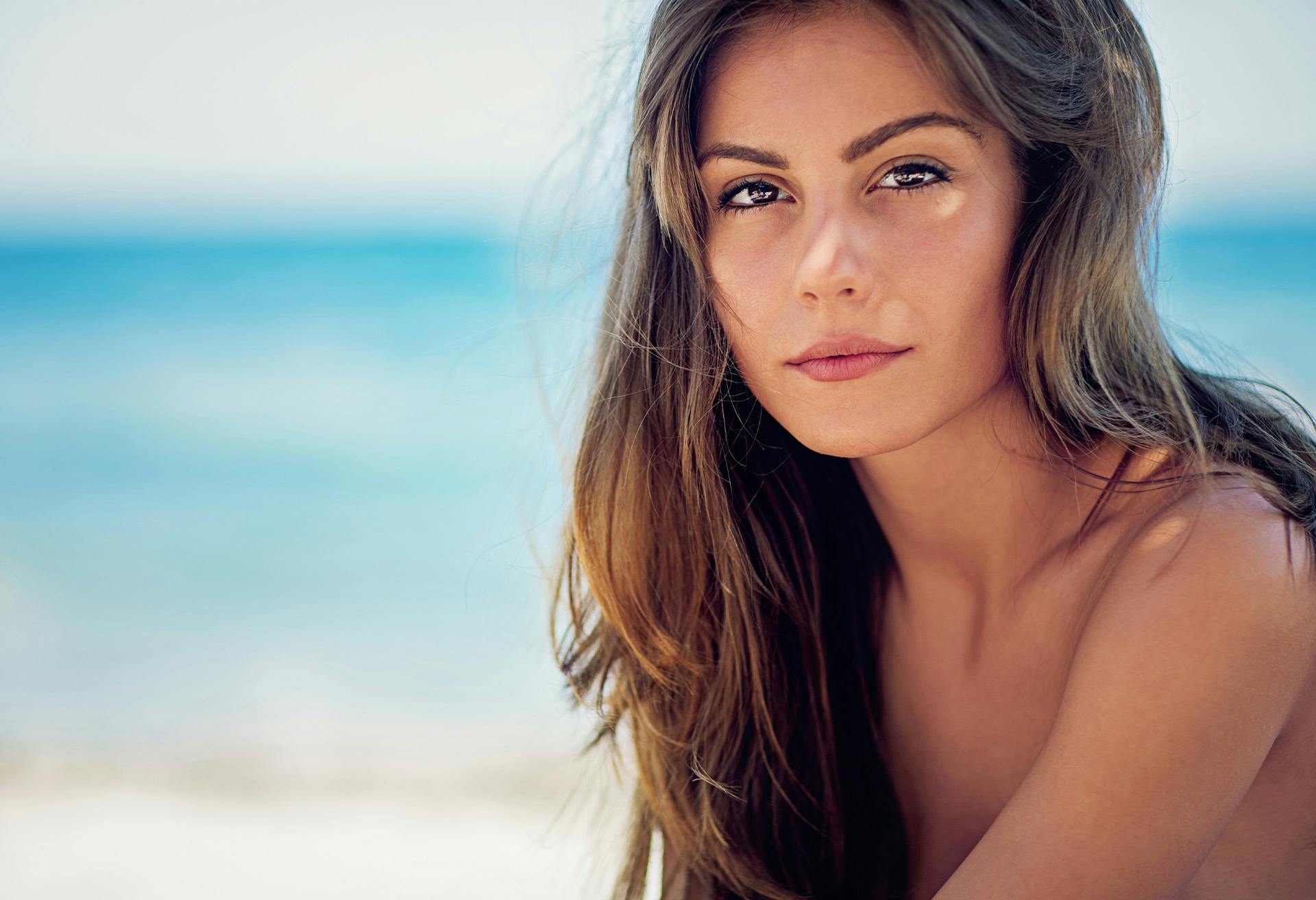 Woman with long brown hair at the beach