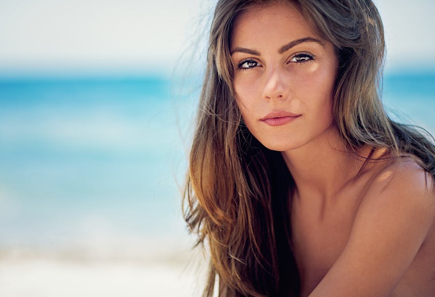 Woman with long brown hair at the beach