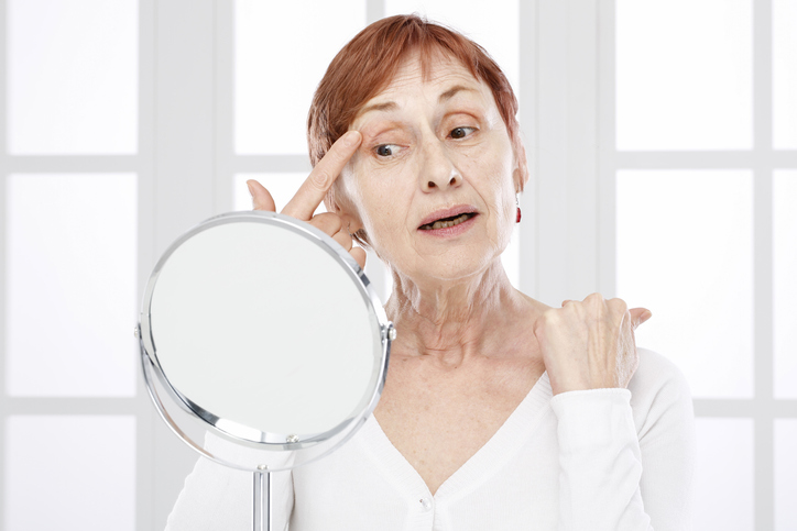 Older woman looking in a mirror