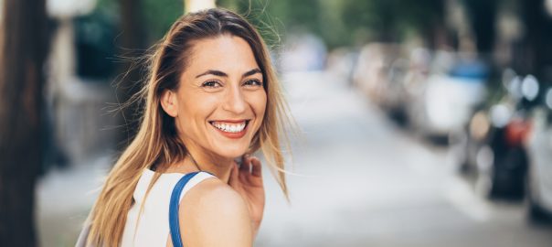 Woman smiling while walking outside