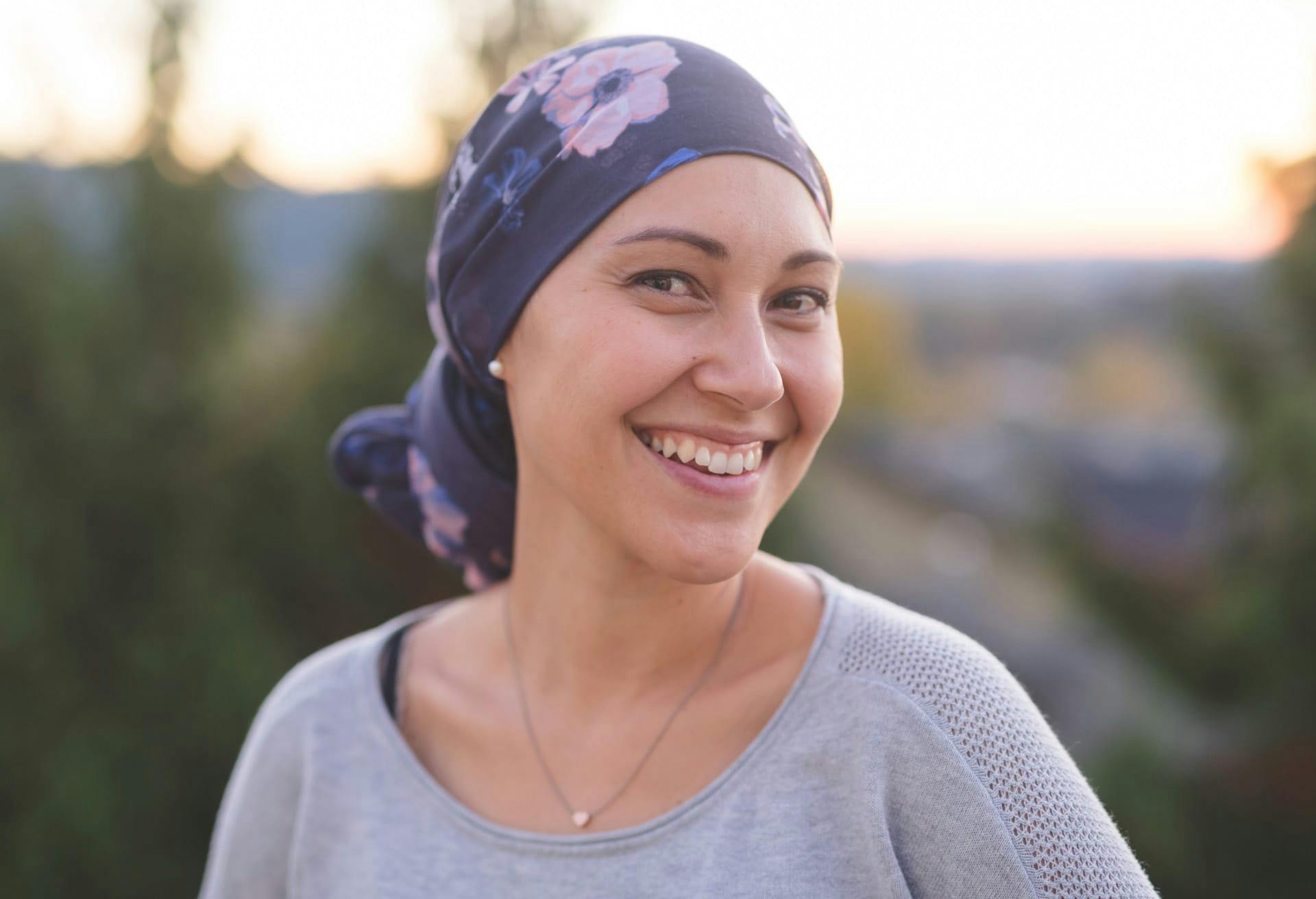 Woman smiling and wearing a scarf on her head