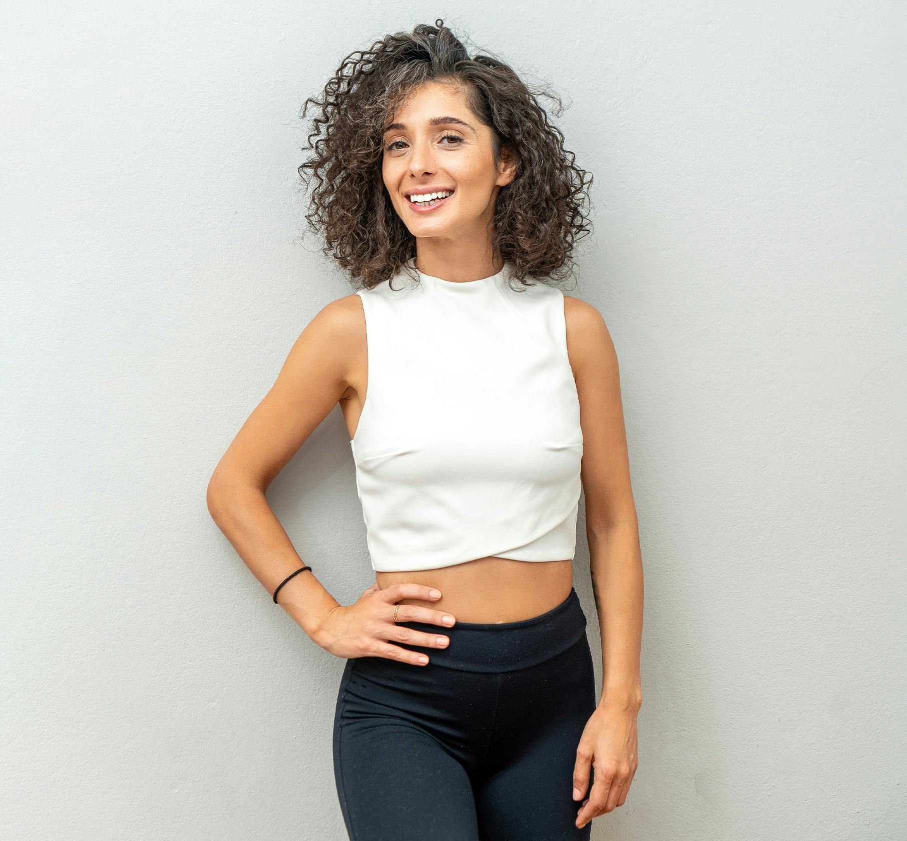 Woman in tank top and hand against her hip