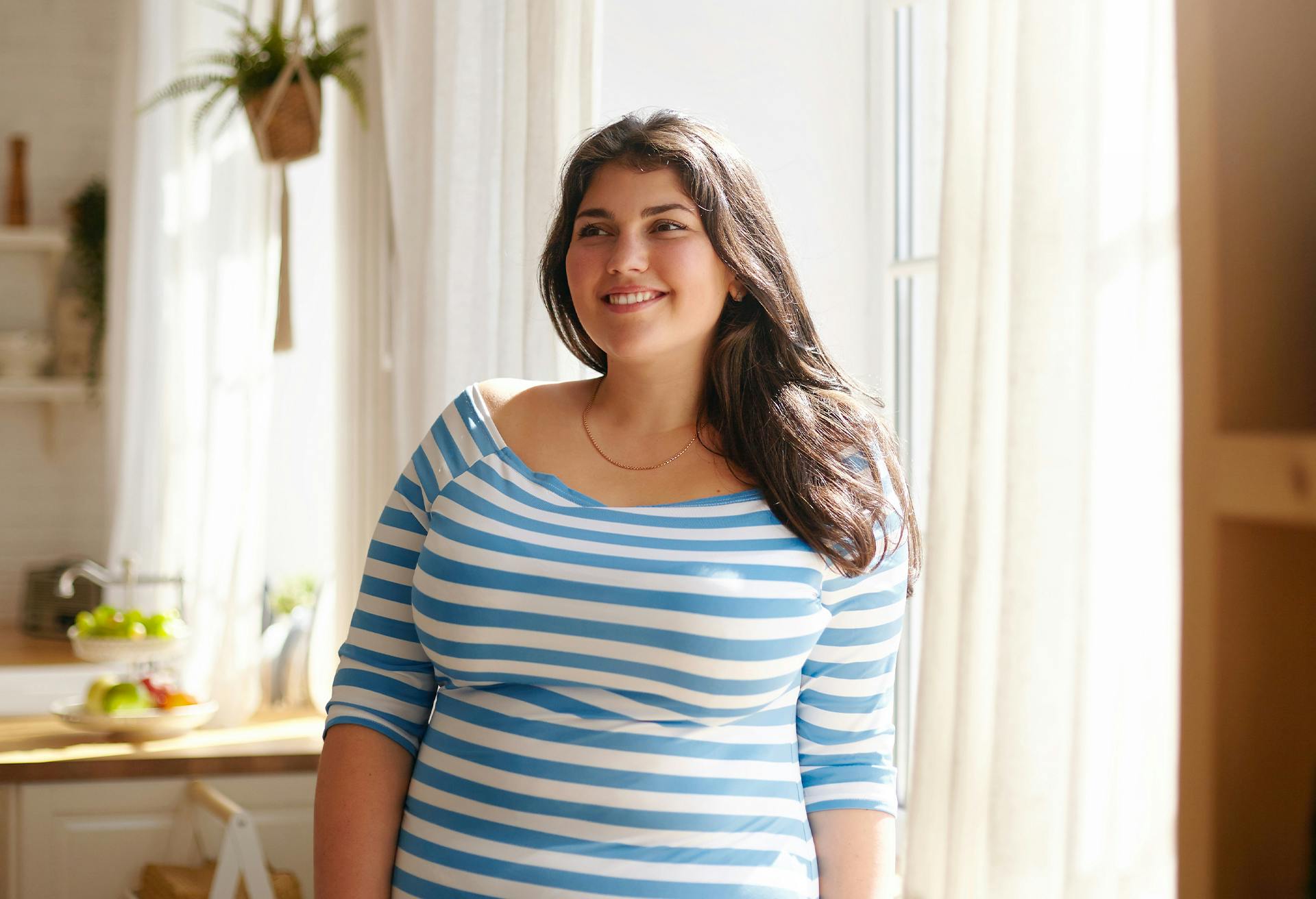 Woman in a blue striped shirt, smiling