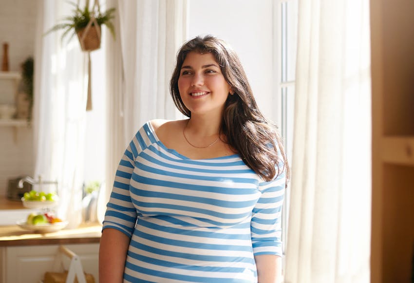 Woman in a blue striped shirt, smiling