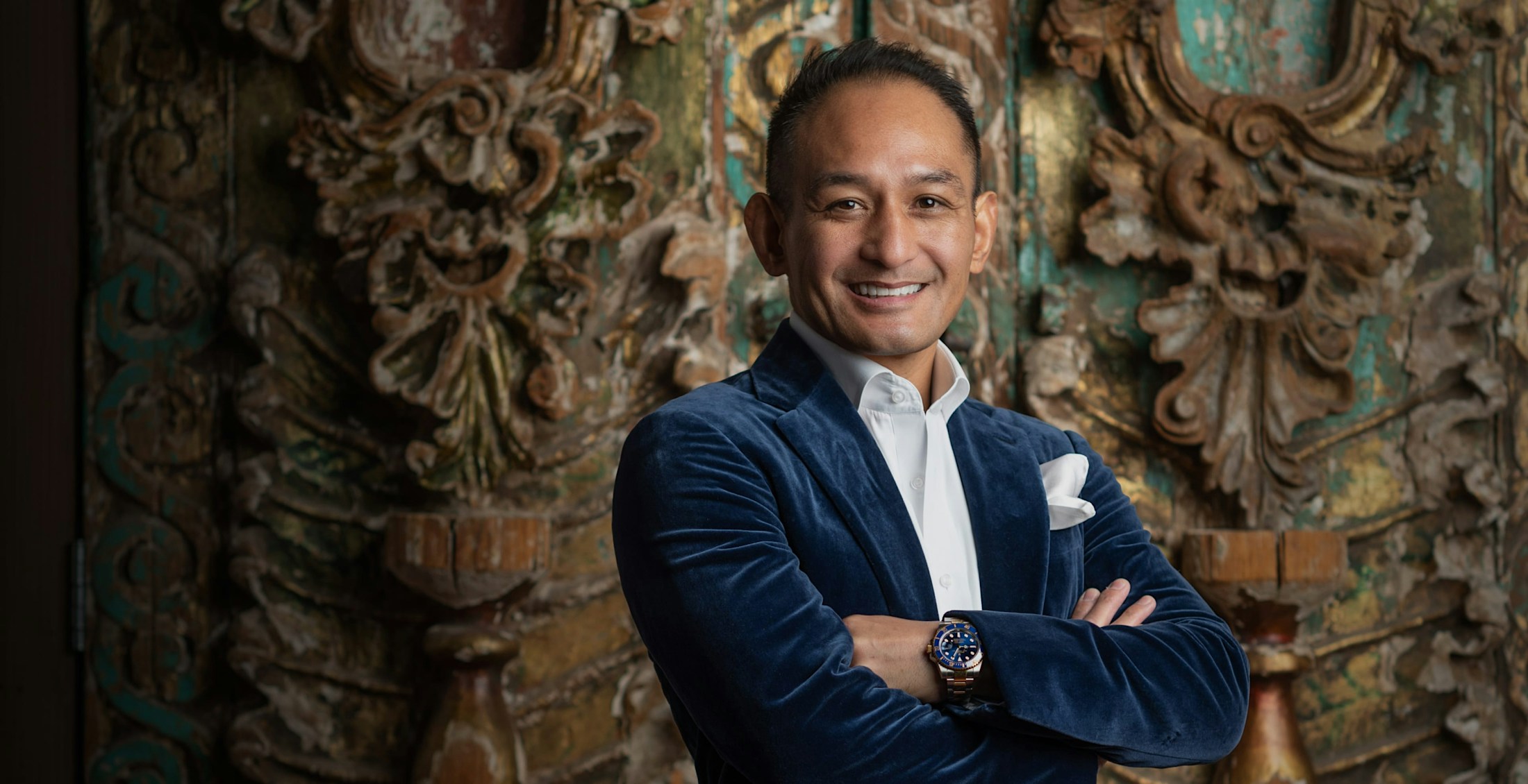 Dr. Andres in a suit and arms crossed