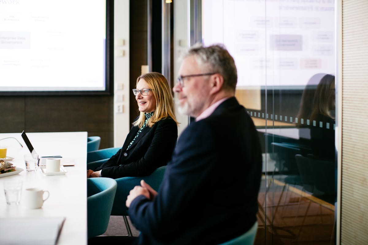 Consultants in a meeting room smiling looking to the left