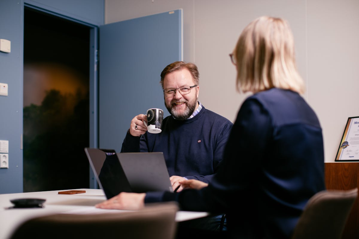 Consultant smiling holding a coffee cup