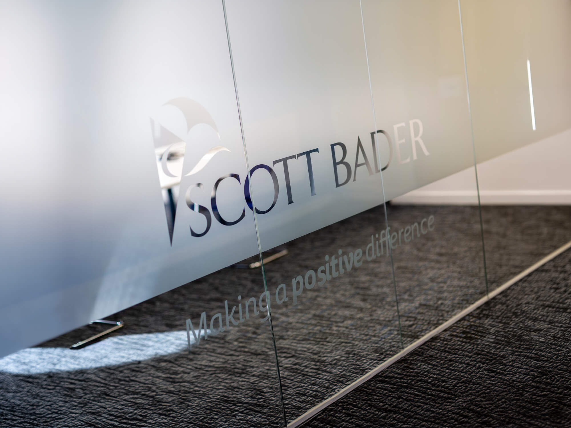 Scott Bader logo on glass.